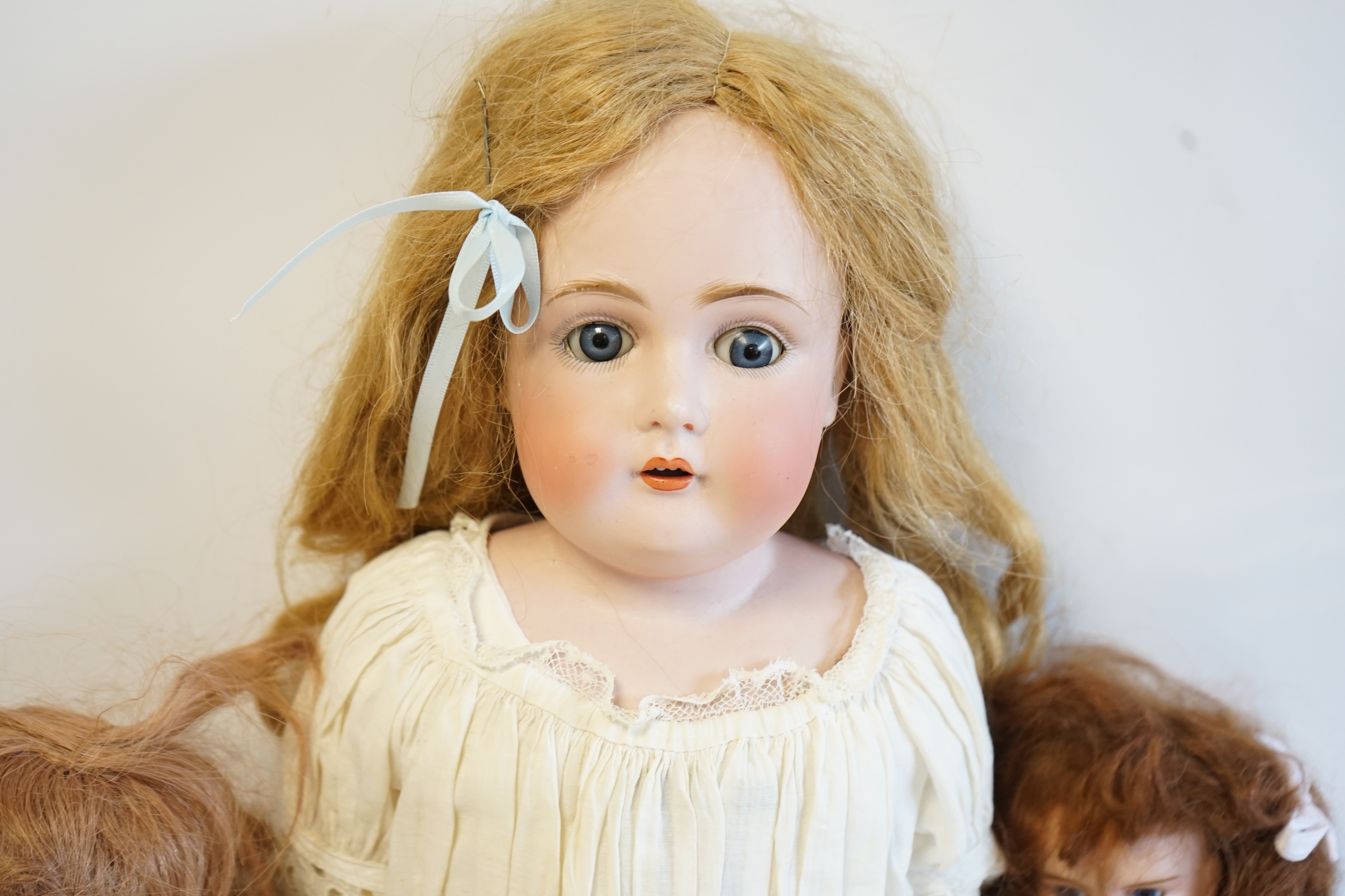 A German bisque shoulder plate doll marked bb on kid body, 60cm high, together with an SFBJ60, 42cm, and a Unis France, 36cm high (3). Condition - good